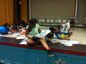 Girls in the Game studying the daily news, July 2013