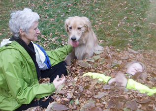 Sara, her granddaughter, and golden retriever Callie spoil Grandpapa Courtenays hard work with the leaves.